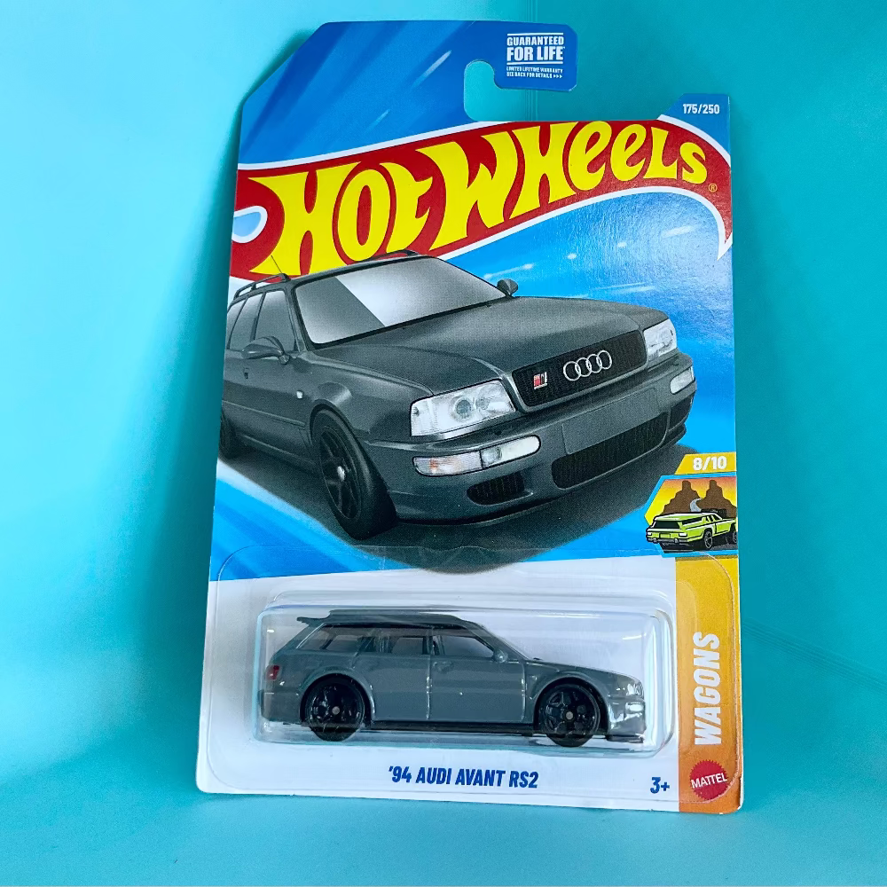 A Hot Wheels '94 Audi Avant RS2 die-cast toy car in its original blister card packaging, displayed against a solid turquoise background.