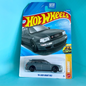 A Hot Wheels '94 Audi Avant RS2 die-cast toy car in its original blister card packaging, displayed against a solid turquoise background.