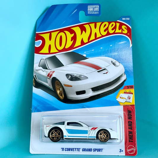 Hot Wheels 'N Corvette Grand Sport' die-cast toy car in its original blister card packaging, set against a bright turquoise background.