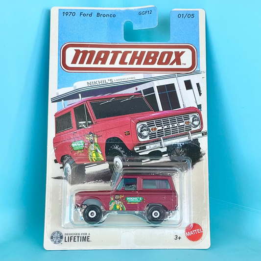 A Matchbox die-cast toy car in its original blister card packaging, featuring a red 1970 Ford Bronco. The packaging shows the Matchbox logo prominently at the top, with a blue header and a white lower section.