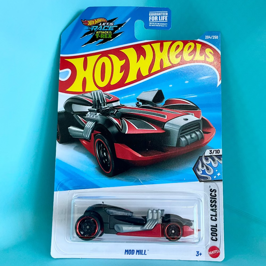 A Hot Wheels toy car in its original blister card packaging, featuring the 'Cool Classics' 'Mod Mill' model. The card is set against a bright turquoise background.
