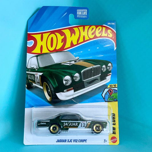 A Hot Wheels toy car in its original blister packaging, featuring a black and gold Jaguar XJC V12 Coupe. The cardback displays the classic red and yellow Hot Wheels logo and a blue background.