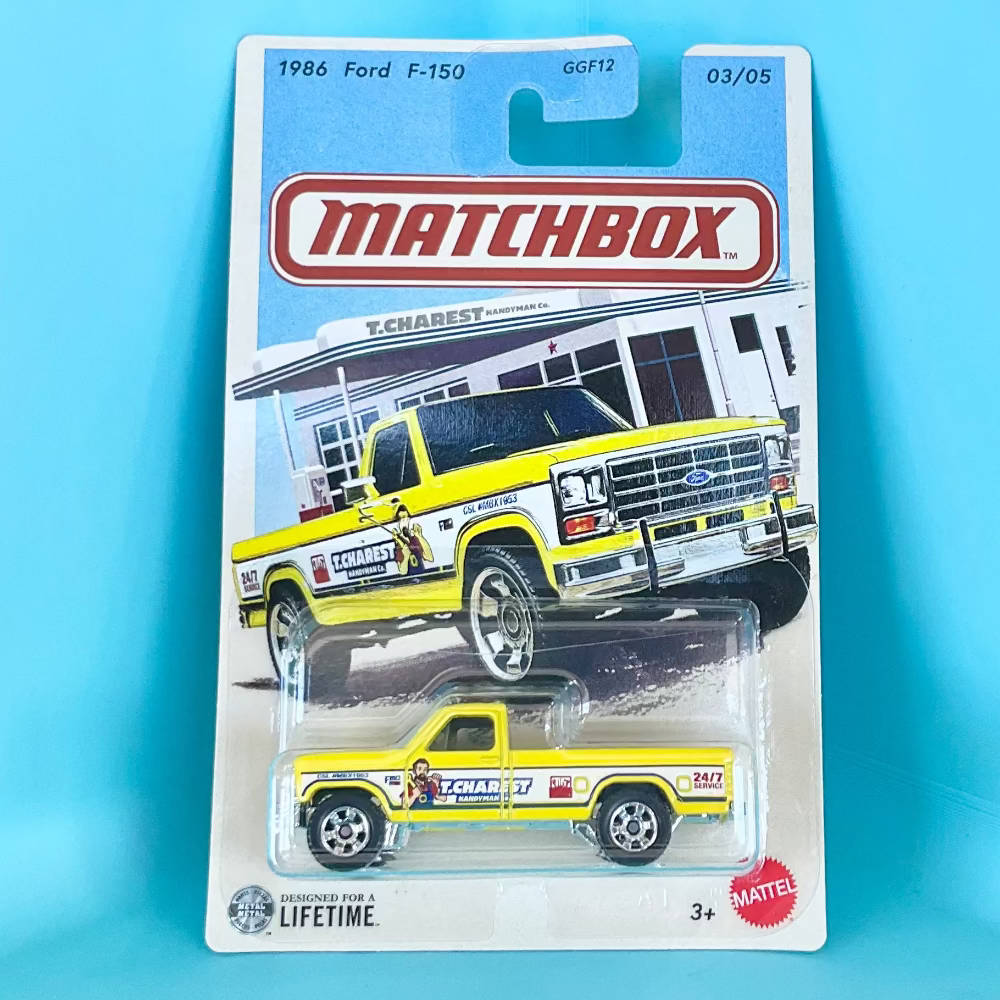 A Matchbox die-cast toy truck in its original blister card packaging, featuring a 1986 Ford F-150. The toy truck is yellow with white and black graphics, and the packaging shows a larger illustration of the same truck.
