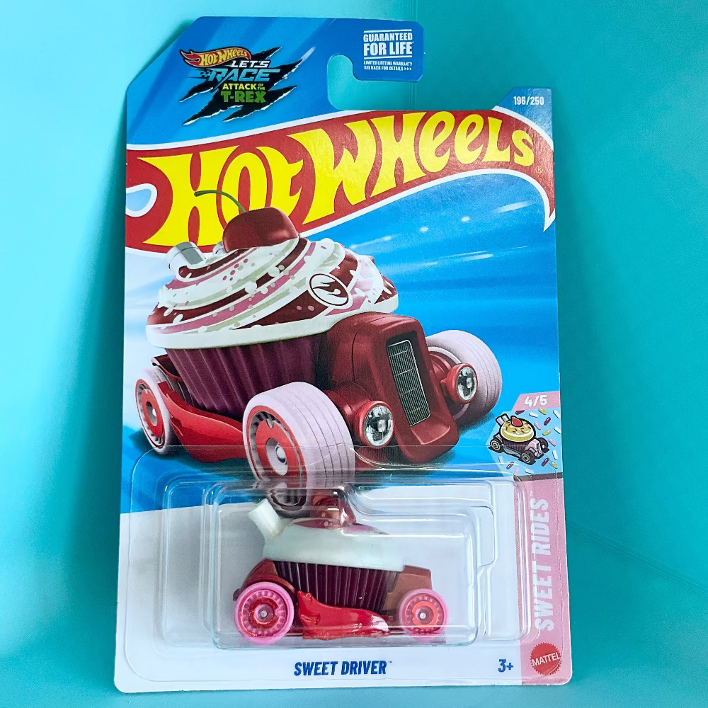 A Hot Wheels Sweet Driver toy car in its original blister card packaging, featuring a red and white cupcake-themed vehicle. The packaging is set against a bright turquoise background.