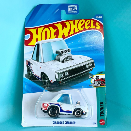 A Hot Wheels '70 Dodge Charger toy car in its original blister card packaging, displayed against a bright turquoise background. The packaging features the classic Hot Wheels logo and depicts a white muscle car with a prominent chrome supercharger.