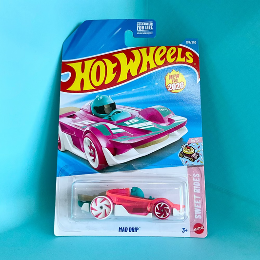 A Hot Wheels Mad Drip toy car in its original blister packaging, displayed against a bright turquoise background. The packaging features the classic Hot Wheels logo and depicts the pink and white toy car inside.