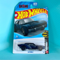 A Hot Wheels Batman Batmobile toy car in its original blister card packaging, displayed against a solid turquoise background.