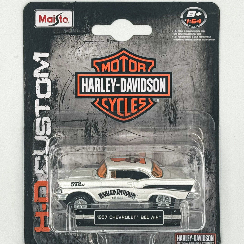 A 1:64 scale model of a 1957 Chevrolet Bel Air by Maisto, packaged in a window display box with Harley-Davidson branding and a stylized backdrop.